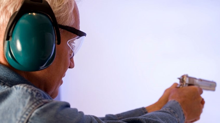 senior lady shooting pistol